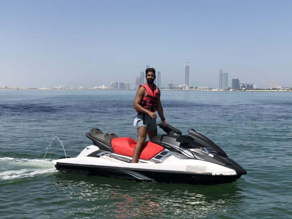 Rider on a jet ski with the Abu Dhabi skyline